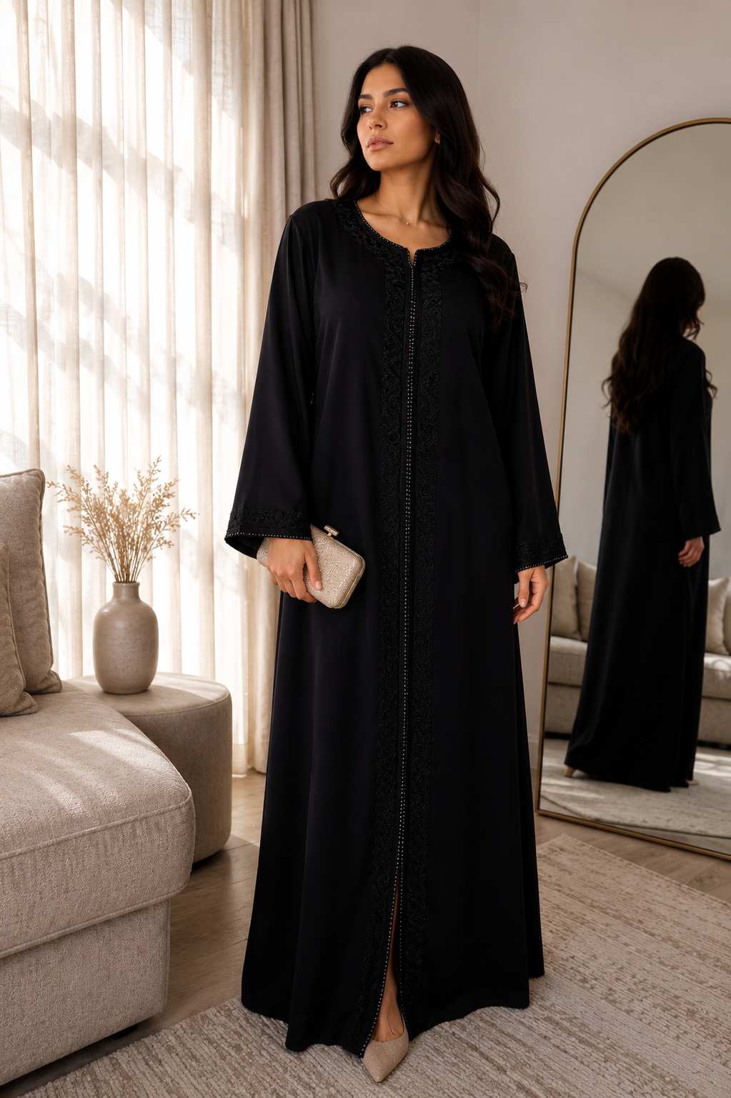 Woman in a black abaya standing in a living room.