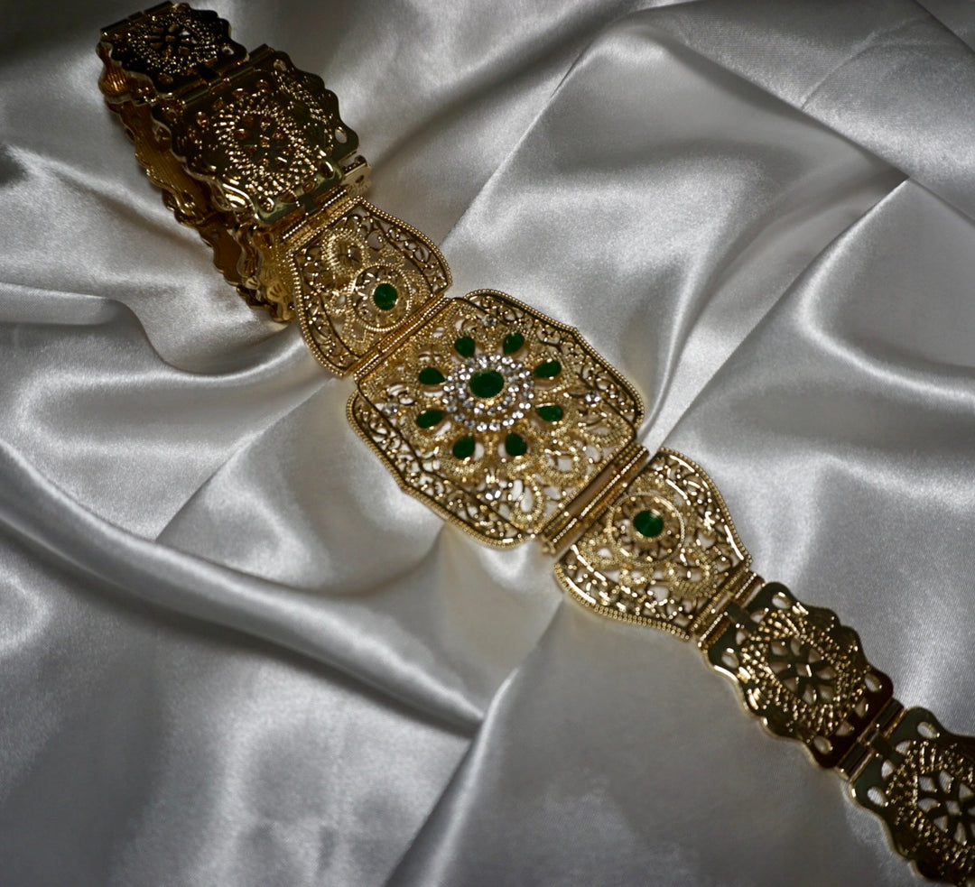 Gold Moroccan waist belt with emerald green gem details on satin background – traditional statement belt for kaftans or special occasions